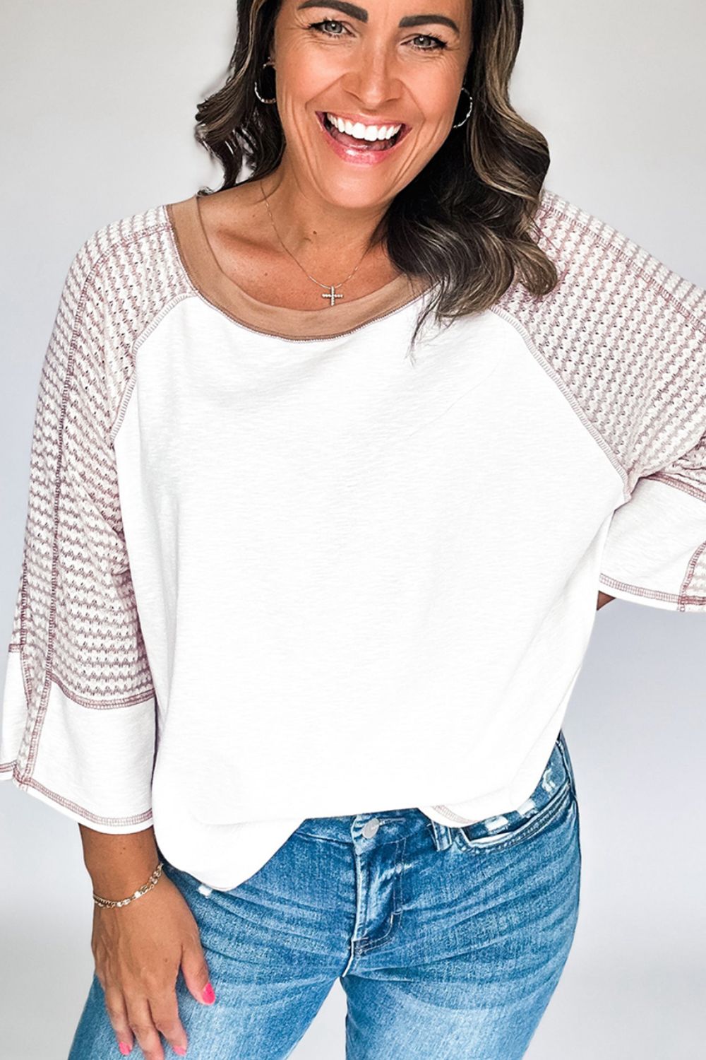 Textured raglan sleeve tee in white with patterned sleeves and contrast neckline.