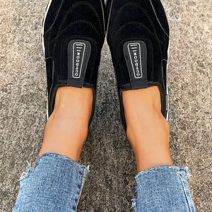 Black suede-like round toe slip-on sneakers with "OUTDOOR" detail.
