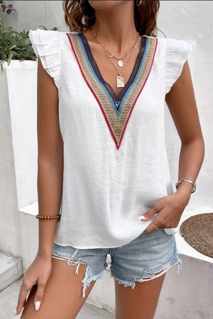 White v-neck blouse with embroidered trim and flutter sleeves