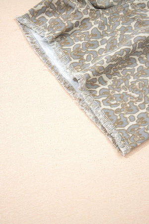Denim shorts with leopard print and frayed hem detail.