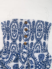 Blue bustier jumpsuit with white floral print and decorative buttons