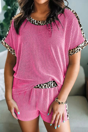Pink ribbed pajama set with crew neck, short sleeves, and leopard trim.