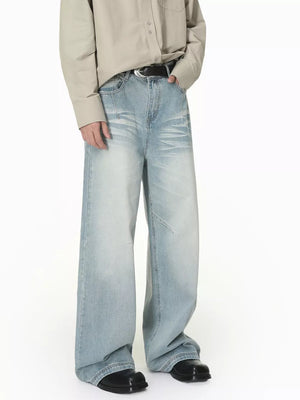 Men's light wash wide-leg cotton jeans with vintage fade and relaxed fit.