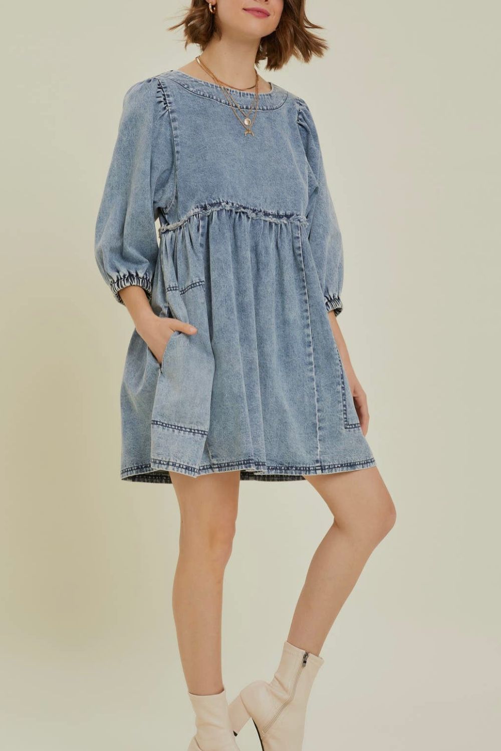 Gathered waist denim mini dress in medium wash with balloon sleeves and pockets.