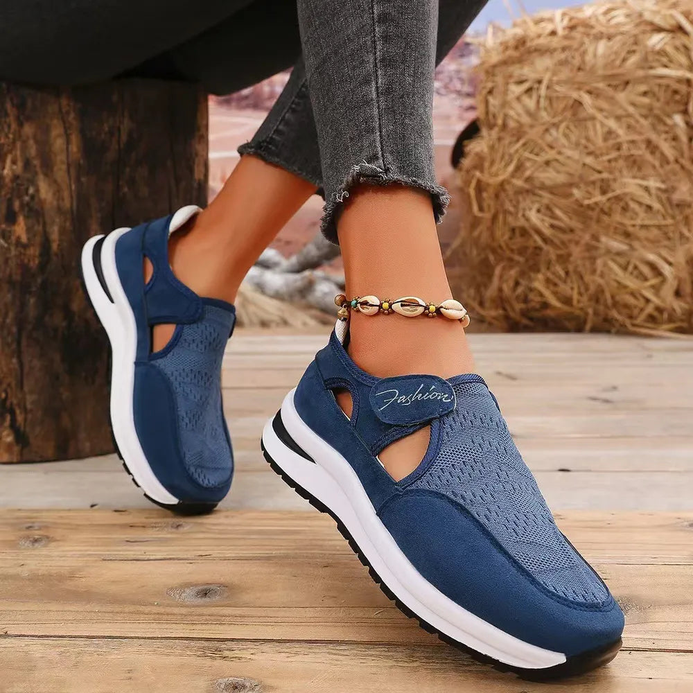 Navy mesh cutout platform slip-on sneakers with white soles and a velcro strap.