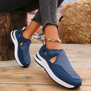 Navy mesh cutout platform slip-on sneakers with white soles and a velcro strap.