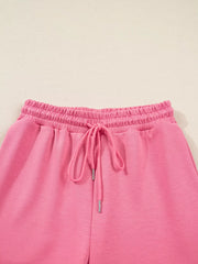 Dusty pink drawstring pants with elastic waistband and tie detail