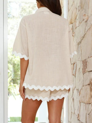 Beige linen lounge set with scalloped edges on short sleeves and shorts.