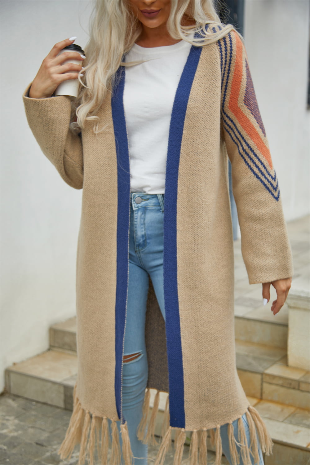 Khaki long cardigan with blue trim and geometric sleeve detail, fringed hem.