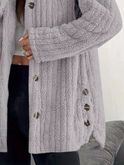 Light grey button-up fleece jacket with textured fabric and brown buttons.
