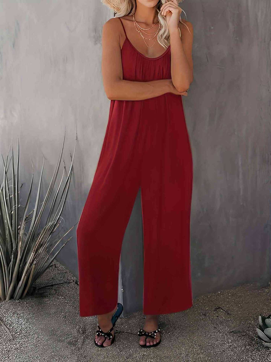 Burgundy gathered bodice wide-leg jumpsuit with spaghetti straps and a flowy silhouette.