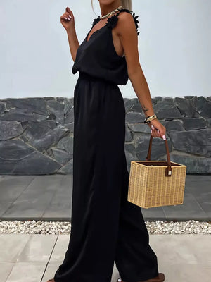 Black wide-leg jumpsuit with floral applique straps and blouson waist