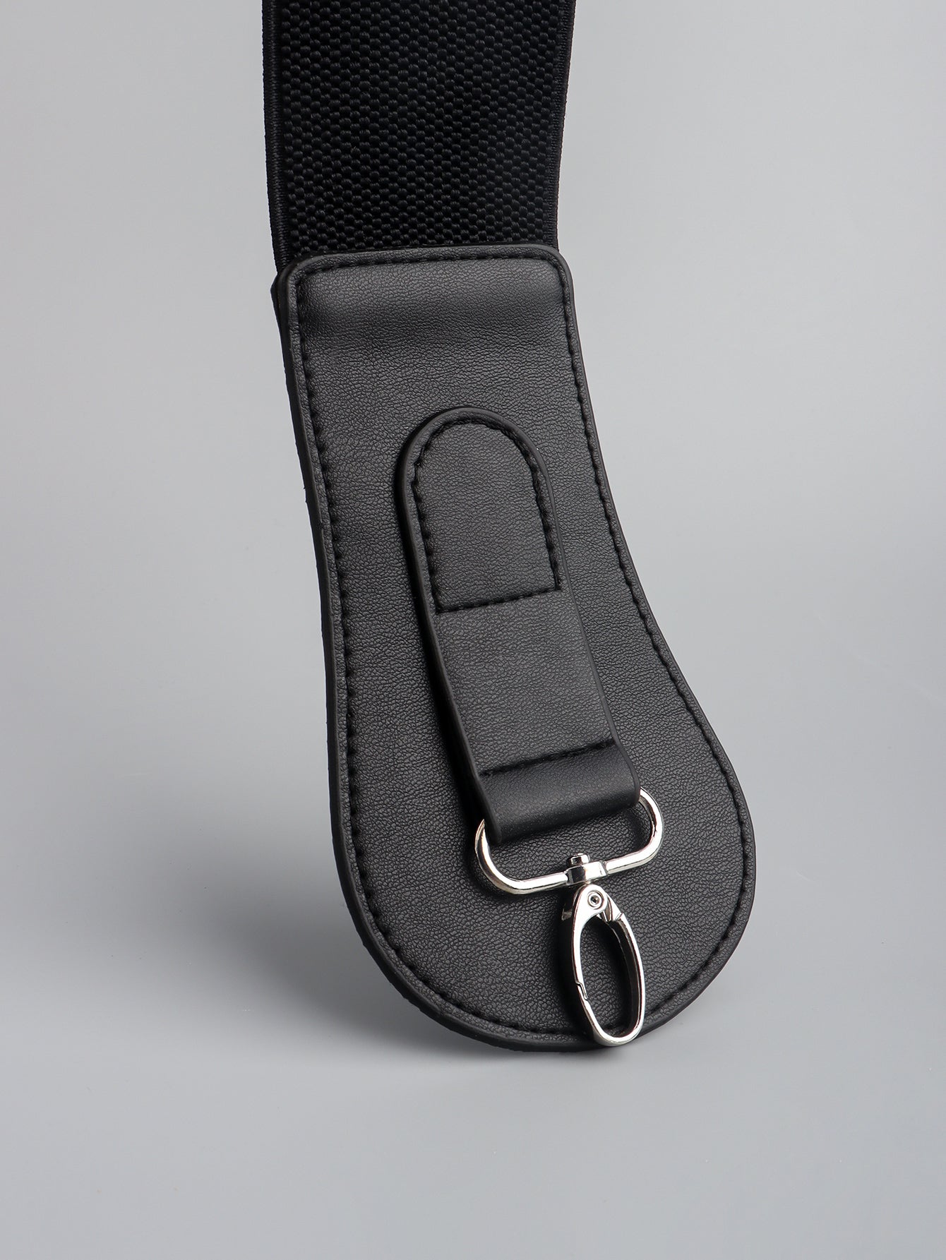 Black leather waist cincher belt with silver hardware detail and elastic strap