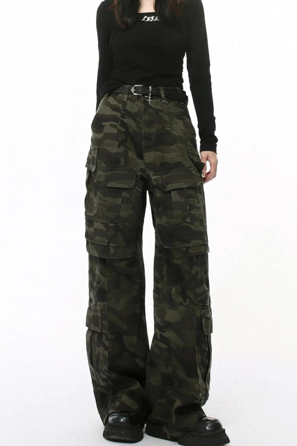 Oversized camo utility cargo pants with multiple pockets and a black belt.