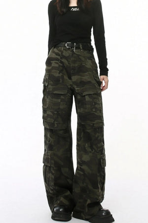 Oversized camo utility cargo pants with multiple pockets and a black belt.