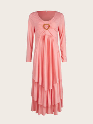 Pink tiered midi dress with long sleeves and a heart detail at the neckline.