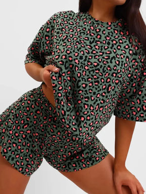 Women's green leopard print pajama set with short sleeves and shorts.