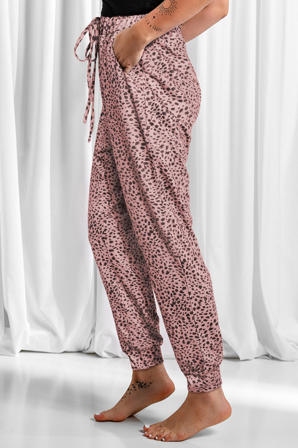 Dusty pink leopard print joggers with drawstring waist and cuffed ankles