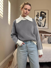 Black and white striped knit sweater with a contrast white collar and cuffs.