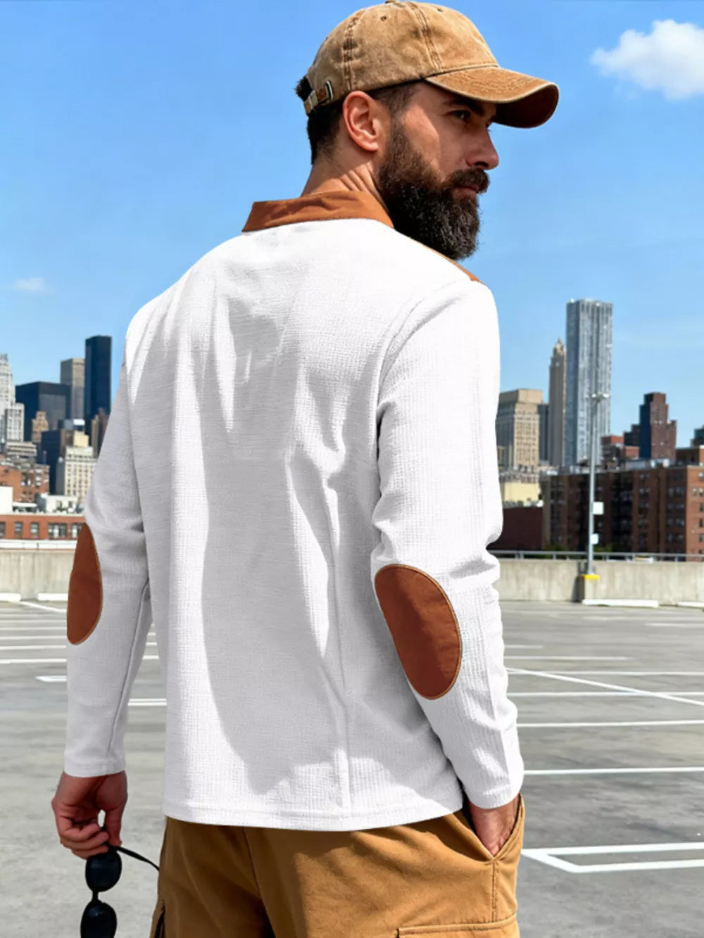 White long-sleeve men's t-shirt with brown elbow patches and collar detail.