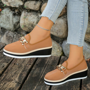 Brown chain decor wedge loafers with a textured finish and stacked sole.
