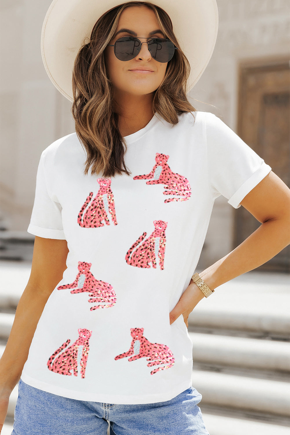 White tee with allover pink sequin leopard print, crew neck, short sleeves.