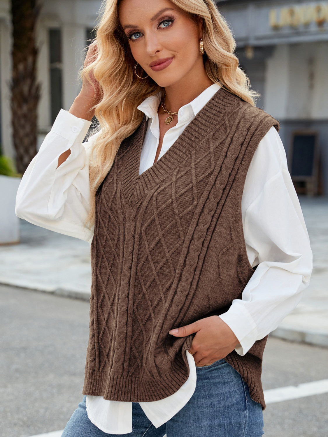 Brown cable knit V-neck sweater vest with diamond pattern detail.