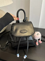 Black leather mini backpack with drawstring closure and beaded details.