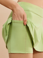 Lime wrap-detail skort with side tie and pocket detail.