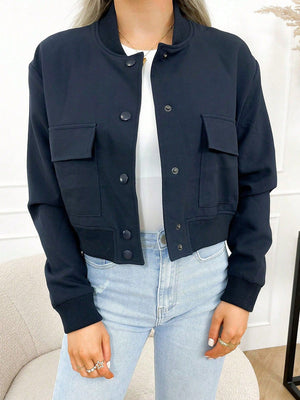Indigo bomber jacket with utility pockets and button closure.