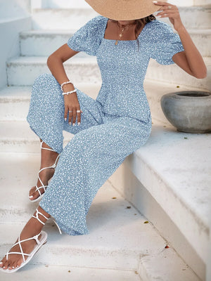 Light Blue floral smocked bodice jumpsuit with puff sleeves and wide legs.