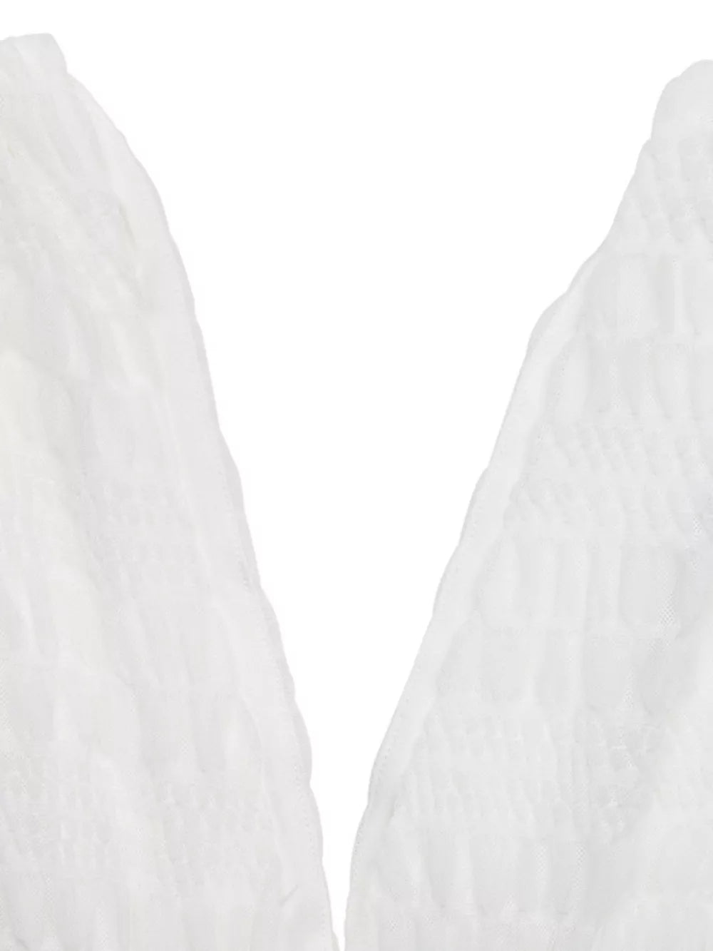 Textured white smocked deep V-neck dress detail.