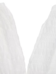 Textured white smocked deep V-neck dress detail.