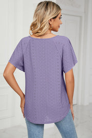 Lavender eyelet tie-neck flutter sleeve blouse with a patterned texture.