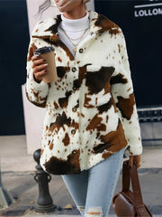 Cow print plush shacket in ivory with brown patches, button front, and chest pockets.