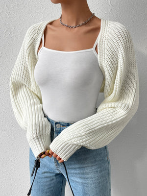 White acrylic knit bolero shrug with long sleeves and ribbed texture.