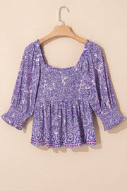 Paisley smocked bodice blouse in lavender with square neck and ruffled cuffs.