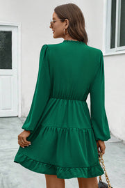 Green tiered ruffle sleeve mini dress with elastic waist and ruffled hem.