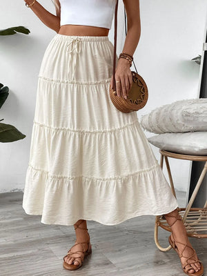 Cream tiered midi skirt with drawstring waist and textured fabric