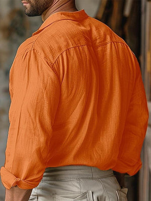 Orange cotton long sleeve button-down shirt with rolled cuffs.