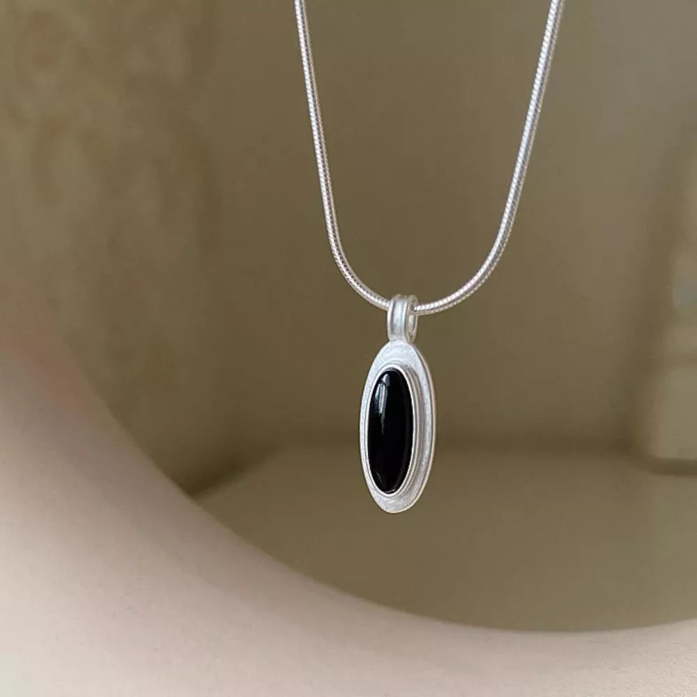 Geometric agate pendant necklace in silver with black stone detail