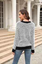 Textured bouclé knit sweater with black contrast trim and a black and white pattern.