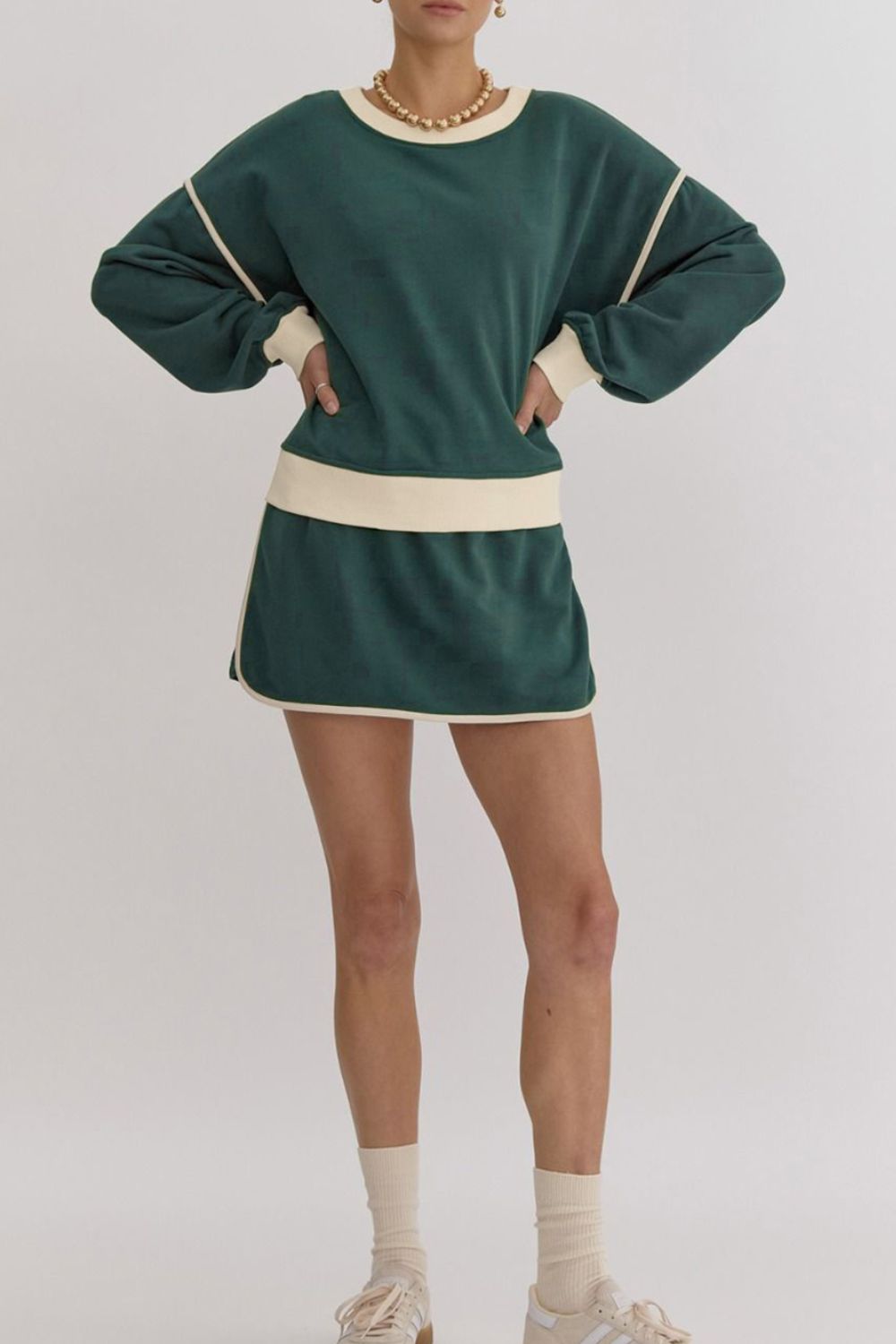 Dark green sweatshirt and skort set with cream contrast trim and crew neck.