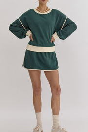 Dark green sweatshirt and skort set with cream contrast trim and crew neck.