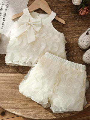 Cream ruffled baby top with bow detail and matching shorts set.