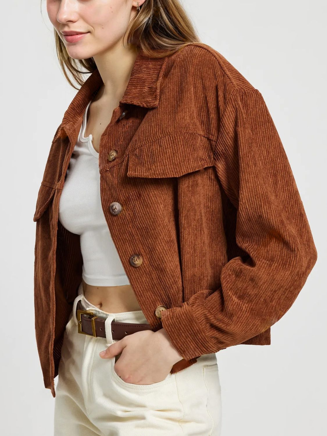 Brown corduroy utility jacket with buttoned patch pockets and collar.
