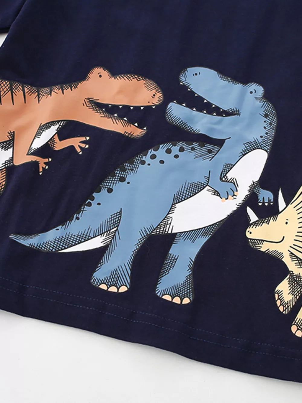 Toddler t-shirt with navy blue cotton and a playful dinosaur print.
