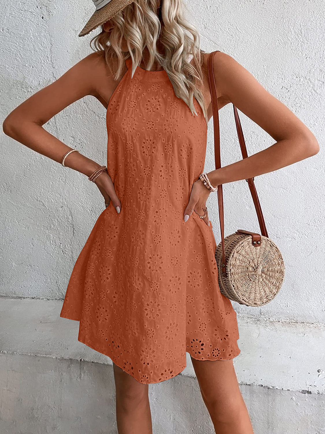 Caramel halter neckline eyelet trapeze dress with a flared hem.