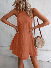 Caramel halter neckline eyelet trapeze dress with a flared hem.