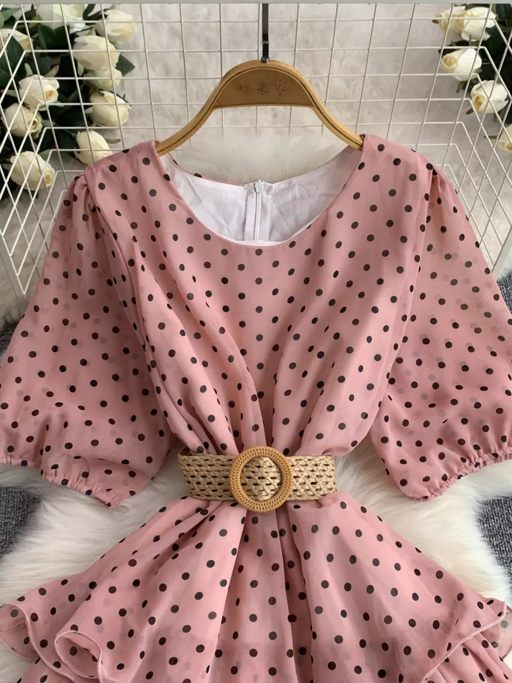 Pink polka dot tiered dress with puff sleeves and woven belt detail